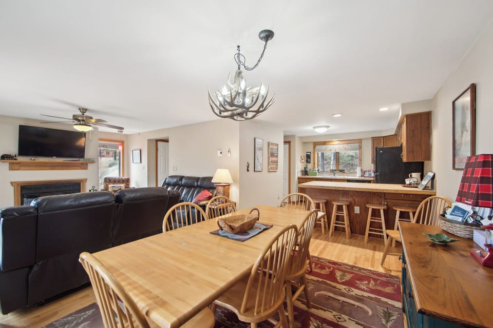 Gather around the dining table for group meals, with the living room and fireplace just steps away. (Sagamore)