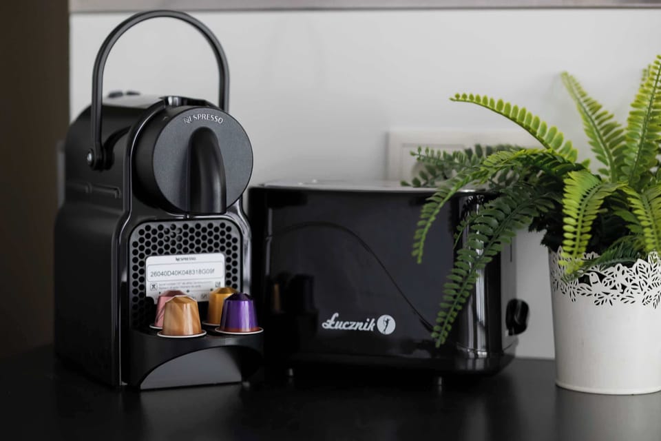 Coffee corner with a Nespresso machine, complimentary coffee capsules, and a selection of tea.