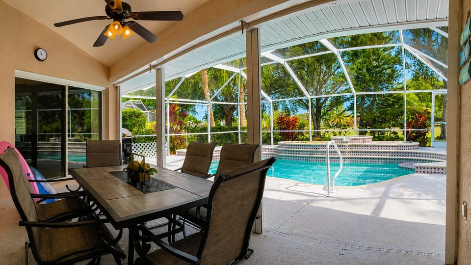 Covered lanai dining with screened pool