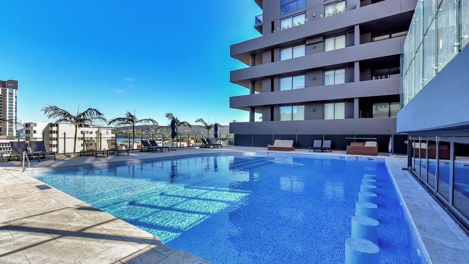 Resort-style infinity pool overlooking the city skyline.