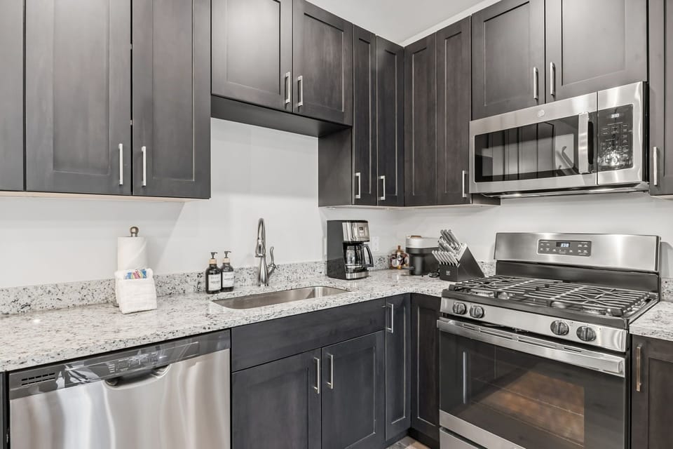 Full kitchen with gas range, microwave and plenty of prep space
