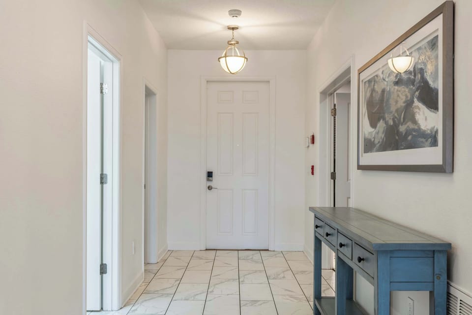 Start your vacation in style with this elegant entrance, featuring a bright, open layout that leads you to beautifully designed living spaces perfect for gathering with loved ones.