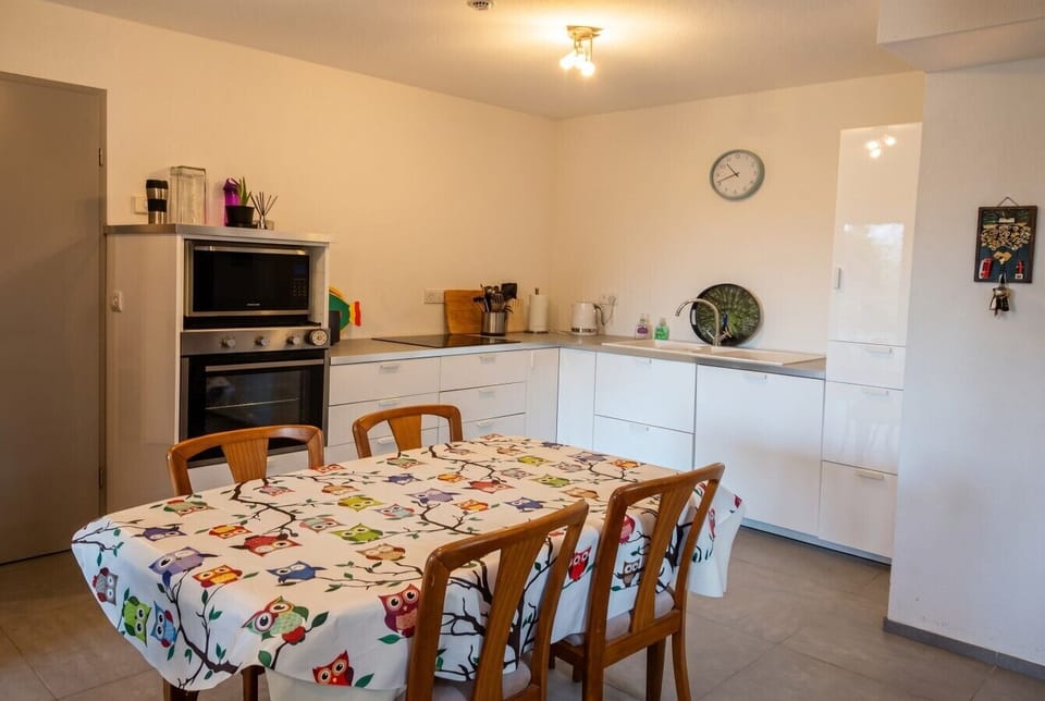 Bright kitchen and dining area with cheerful table for shared meals.