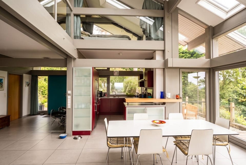 Striking open-plan living framed by architectural glass and beams