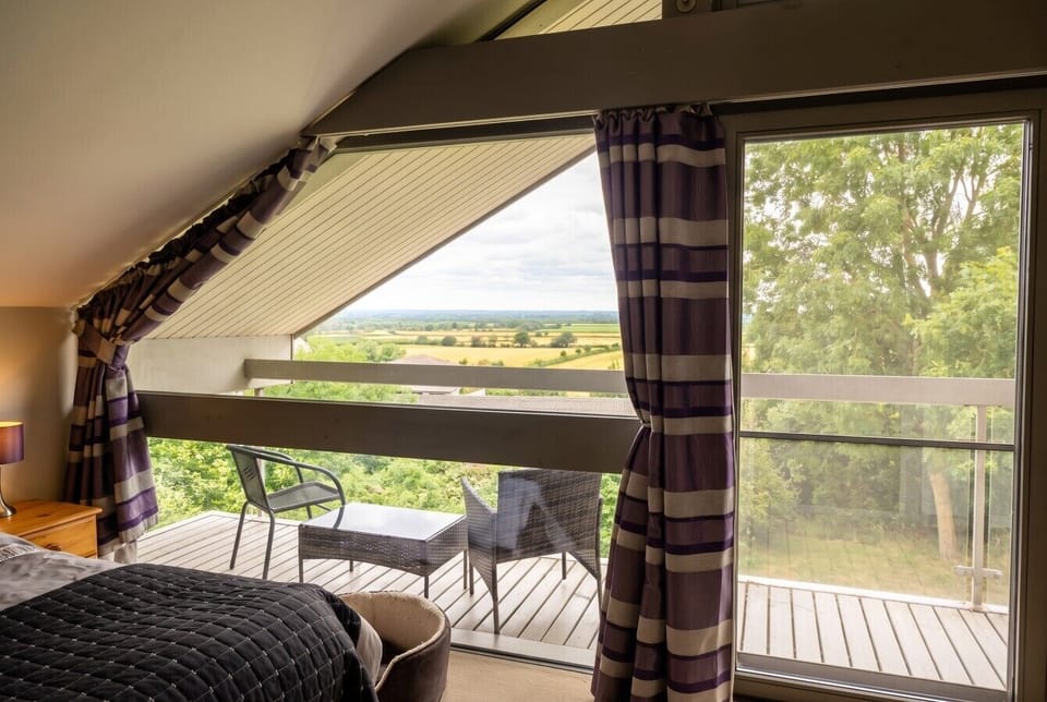 Wake to rolling countryside views from your own private balcony