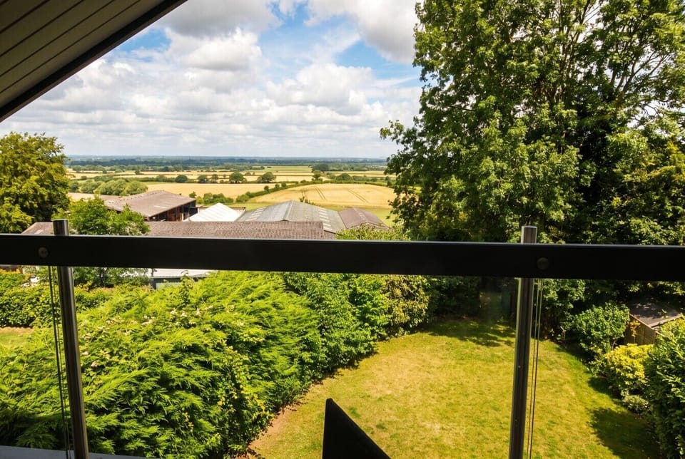 Sweeping views over fields and farmland from the glass balustrade