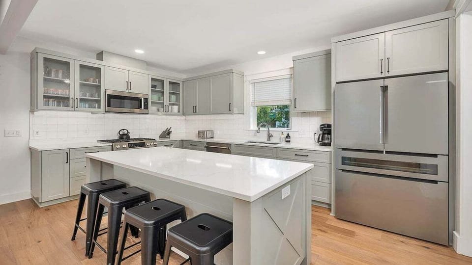 Your culinary haven awaits in this beautifully appointed kitchen, where gleaming countertops, modern appliances, and a spacious island invite you to cook and gather with ease.