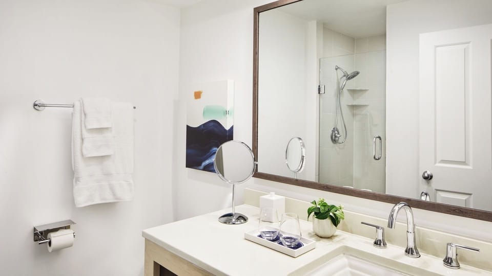 Refresh in the bright bath with a spacious glass shower.
