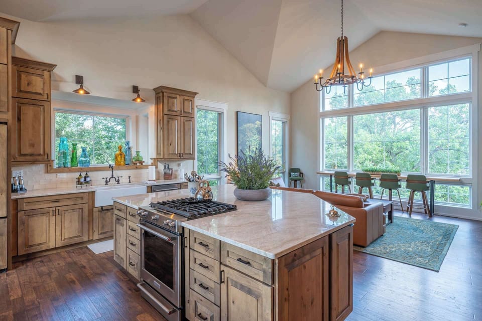 Chef’s kitchen with a large island, gas cooktop and open lake-view living area