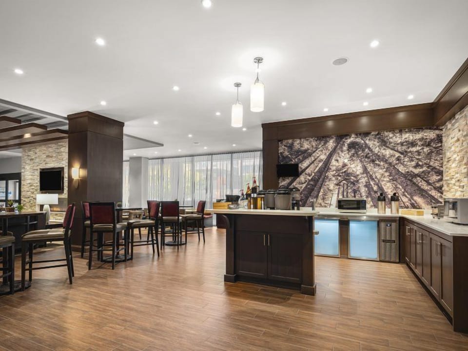 Bright, open breakfast dining area with tables and chairs