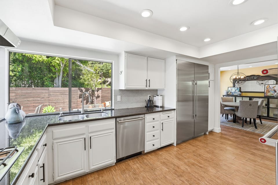 Fully Equipped Kitchen with SS Appliances, looking at gorgeous rear yard patios