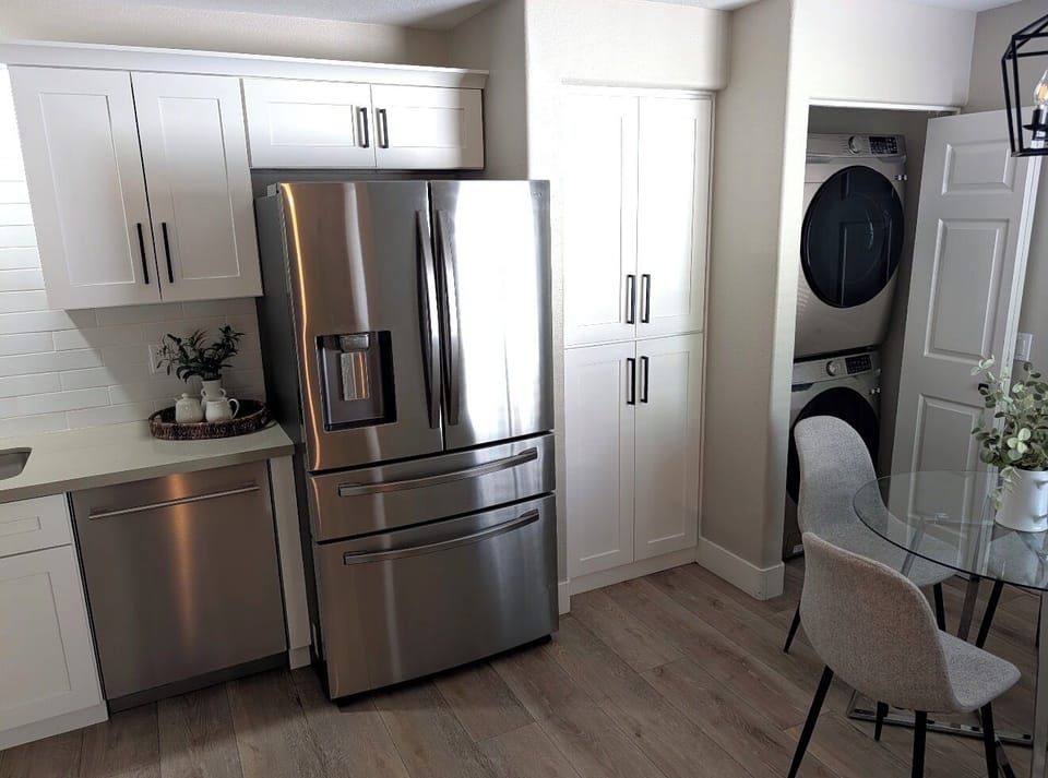 Bright modern kitchen with stainless appliances and in-unit laundry