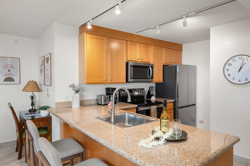 Prepare meals with ease in the well-appointed kitchen, complete with granite surfaces and convenient counter seating.