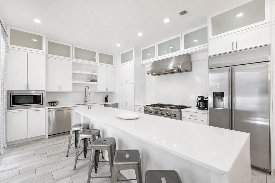 2nd Floor - Group-ready kitchen with an oversized island, six-burner gas range, double ovens, two dishwashers, beverage cooler, and ice maker.