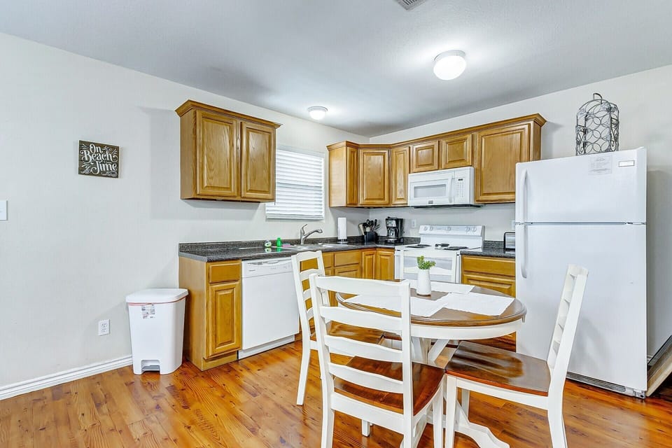 Bright full kitchen with dining for four and warm wood finishes