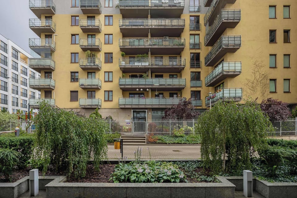 View of the apartment building and its beautifully landscaped courtyard.