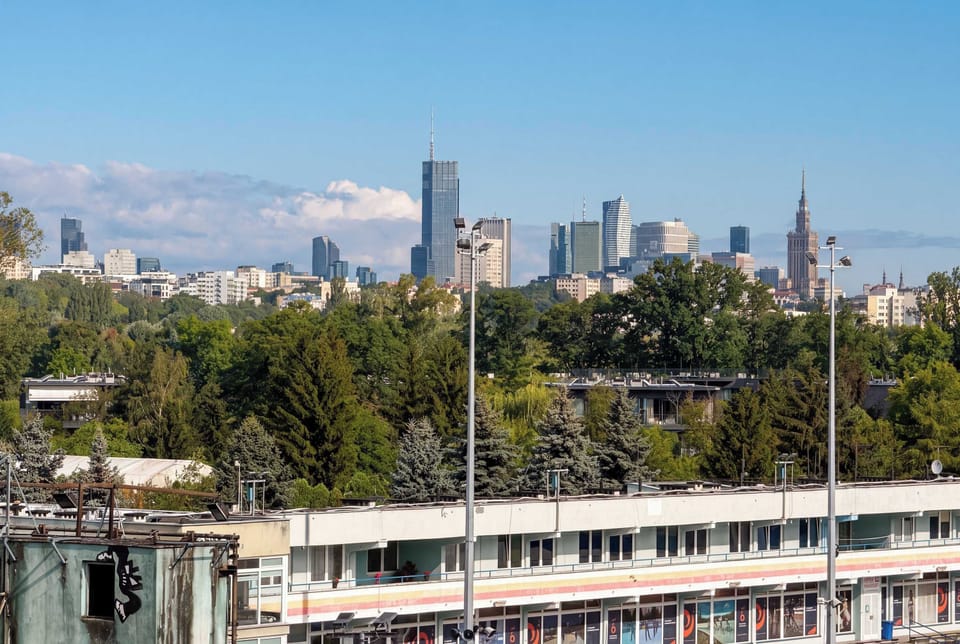 Panoramic city view overlooking the surrounding buildings and green spaces.