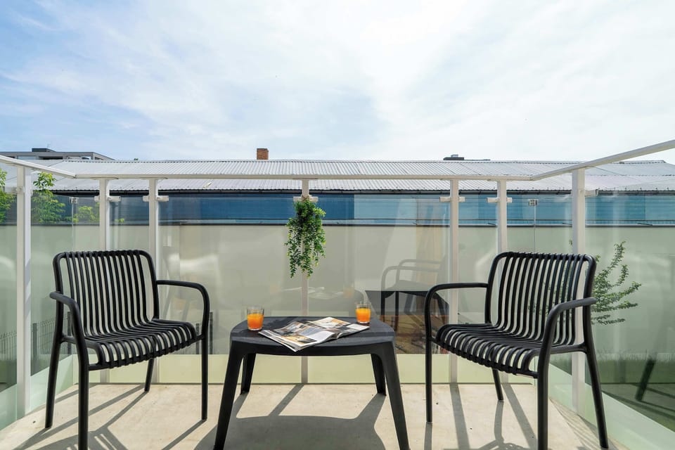 Sunny terrace furnished with outdoor seating and offering an inviting space to relax.