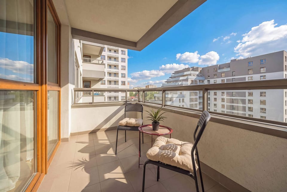 Spacious balcony with outdoor seating.