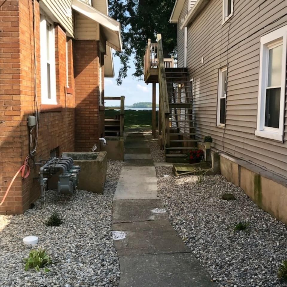 Walkway to lake from front door of cabin. Enjoy the common area yard ahead of the gray house for our vacation rental guests.