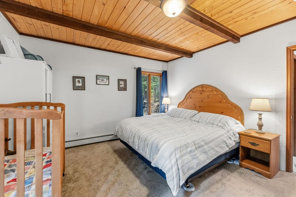 Drift off beneath beautiful wood beam ceilings and wake to soft light streaming through your window—a cozy, peaceful retreat perfect for restful nights.