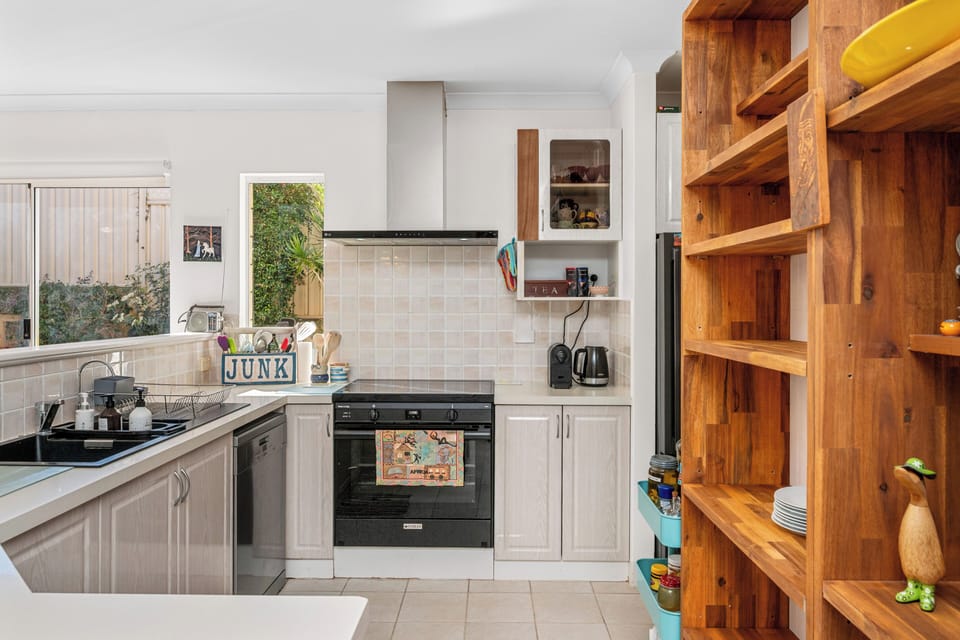 Whip up your favorite meals in this bright and functional kitchen equipped with modern appliances, ample counter space, and a warm, welcoming feel.