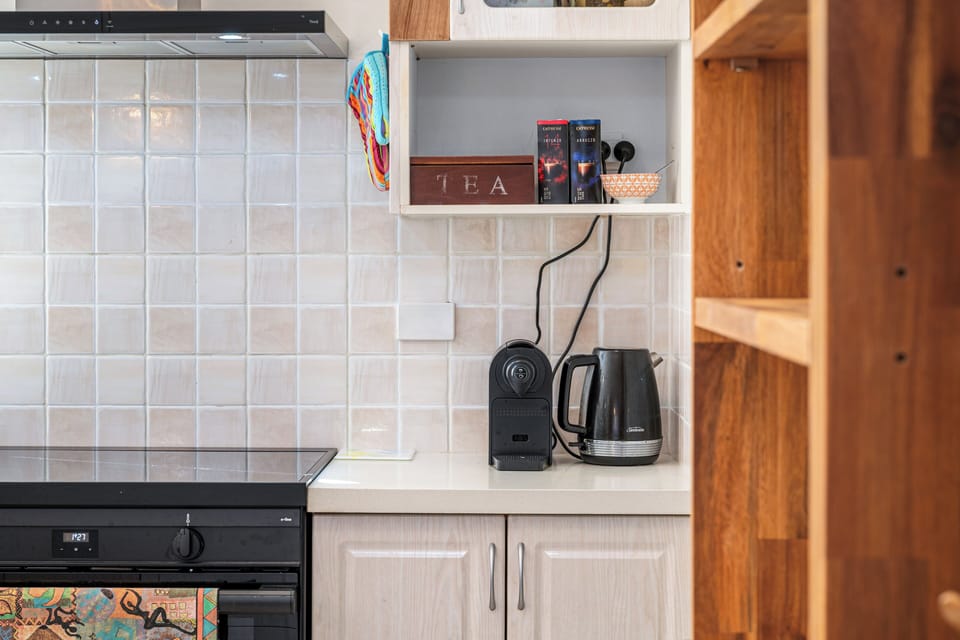 Kickstart your morning with a fresh brew using the convenient coffee machine and electric kettle provided.