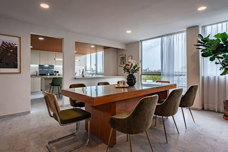 Dining area with seating for eight and abundant natural light.