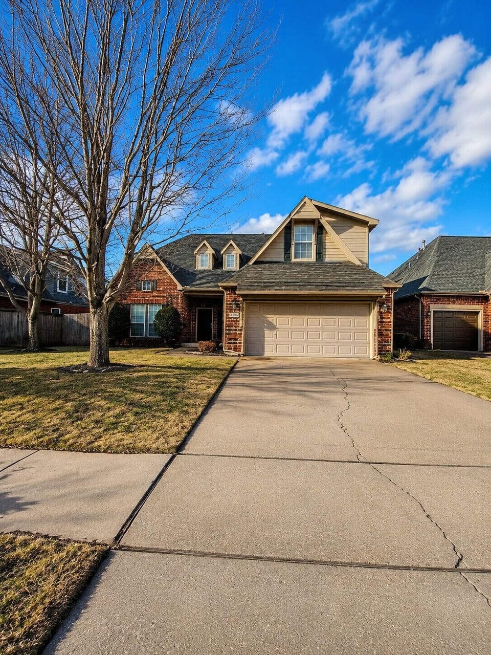 Spacious driveway and attached garage in a quiet neighborhood.