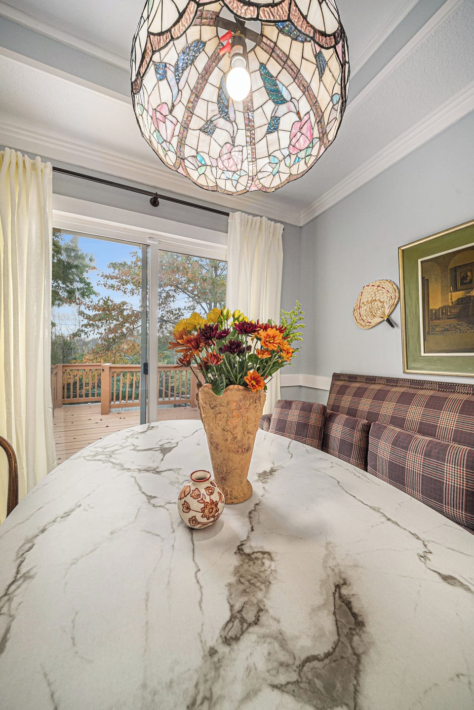 Cozy dining nook with deck views and warm natural light.