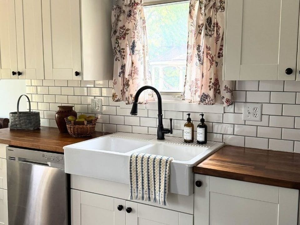 Charming farmhouse sink with warm wood counters and natural light.