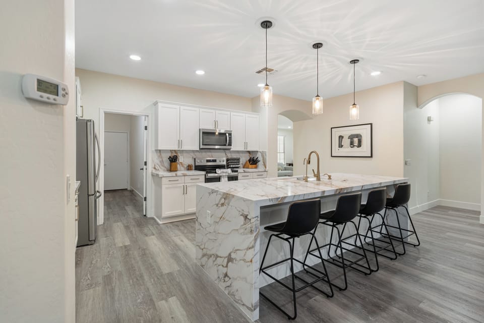 Bright modern kitchen with waterfall island and seating for four