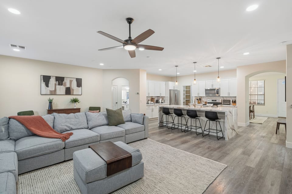 Bright open living space with large sectional and stylish kitchen island