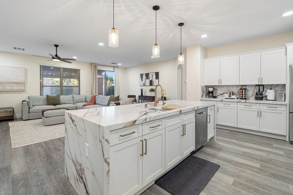 Bright open-concept kitchen with waterfall island and cozy living space