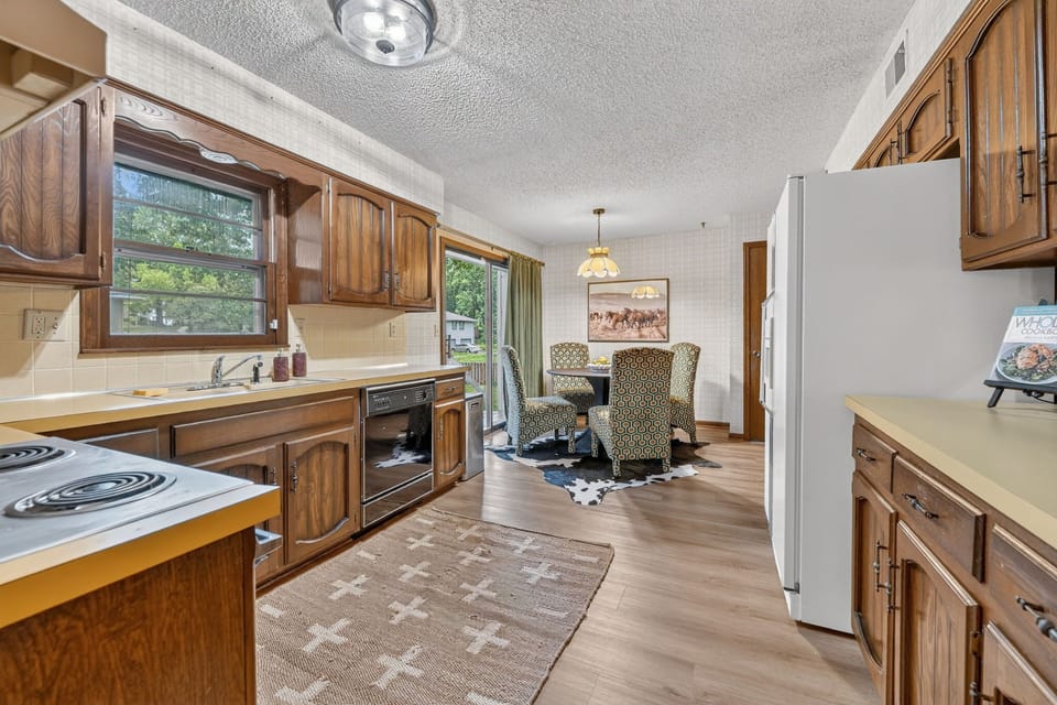 Functional galley kitchen with generous storage and modern appliances.