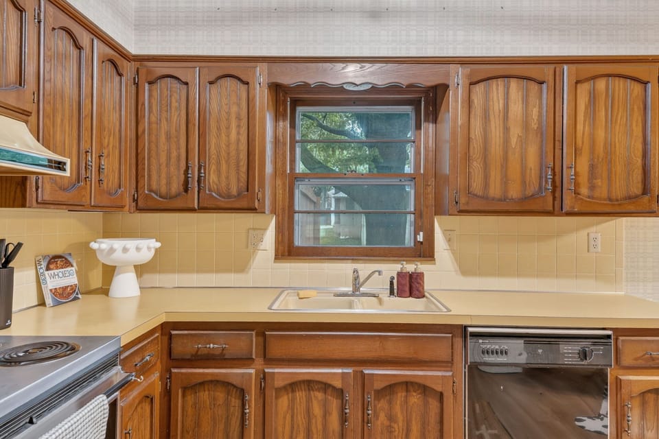 Bright kitchen workspace with rich wood finishes and ample counter space.