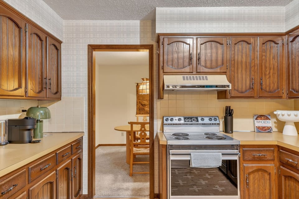 Charming kitchen entry with warm wood cabinetry and inviting character.