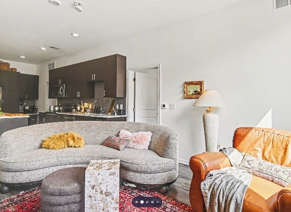Stylish open living space with cozy seating and modern kitchen.