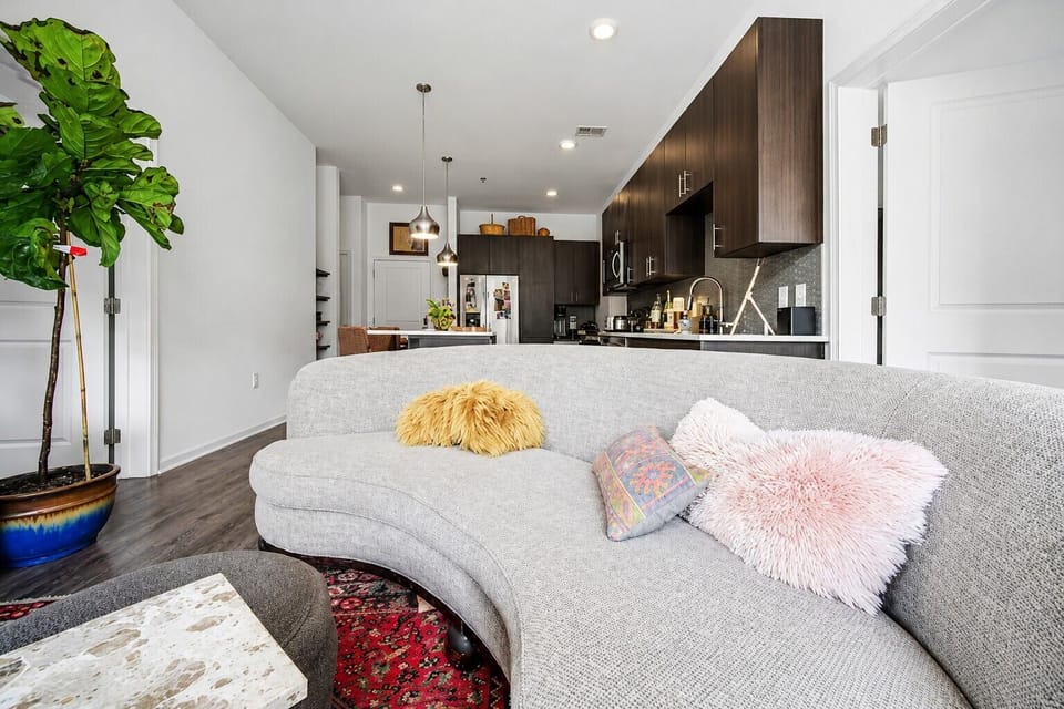 Open concept living space with stylish decor and cozy seating.