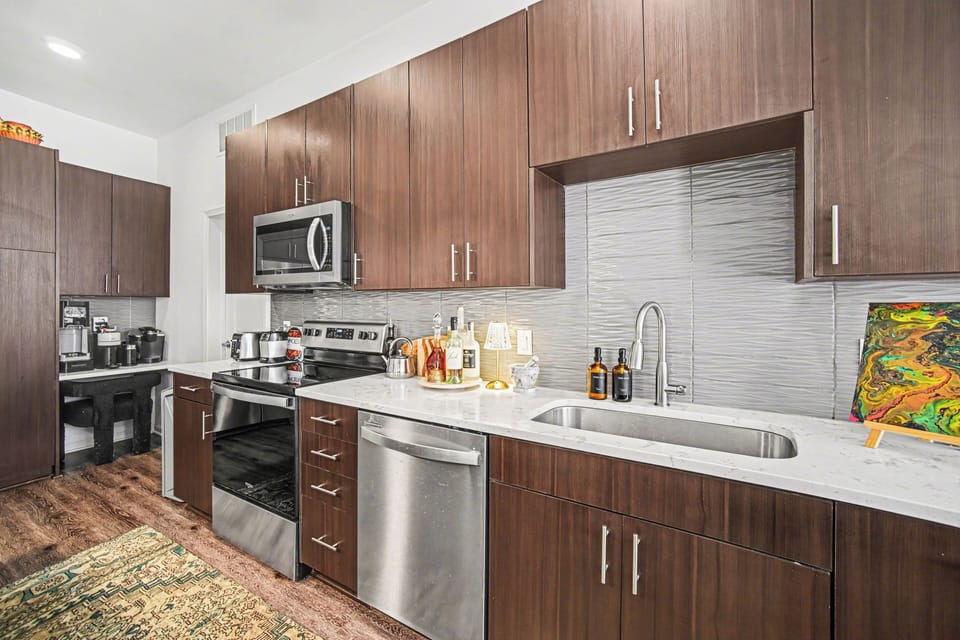 Modern kitchen with sleek finishes and stainless appliances.