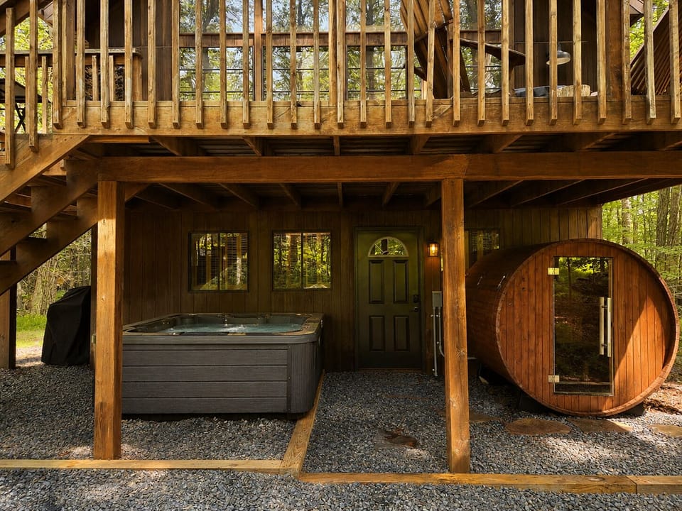 Private hot tub & barrel sauna under a spacious forest deck