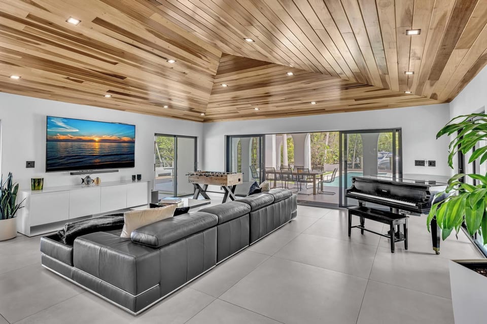Elegant living room view highlighting wood ceilings, and water views.