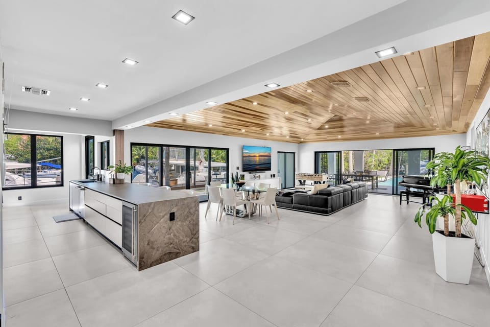 Wide angle view of the open-plan modern living space and kitchen.