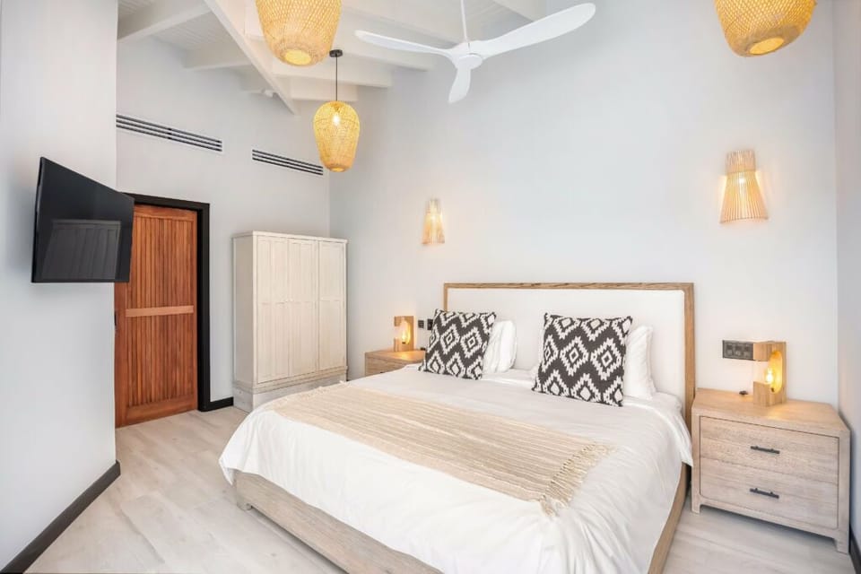 Wake up in crisp linens under warm woven lighting.