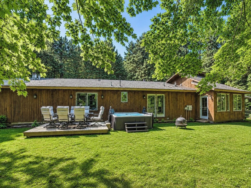 Private backyard designed for gathering and unwinding with new hot tub, dining, and firepit