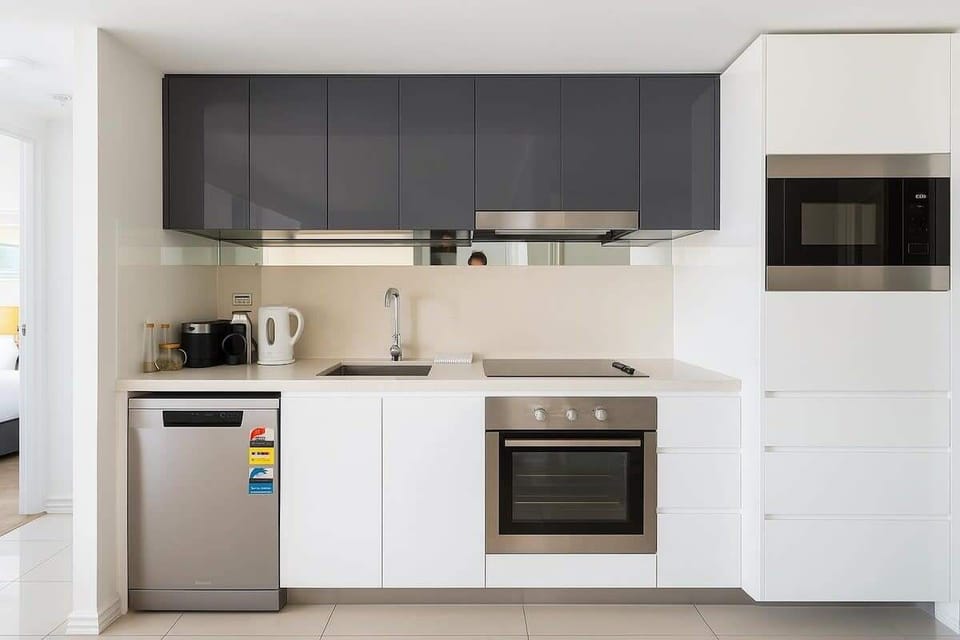Fully equipped kitchen with oven, cooktop, microwave and fridge