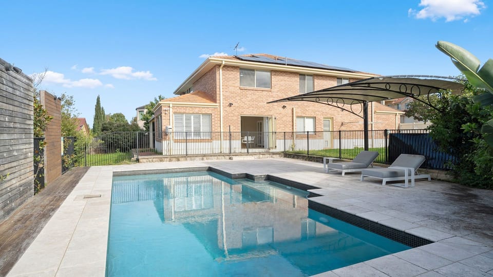 Take a refreshing dip in the private swimming pool surrounded by sun loungers and tropical landscaping.