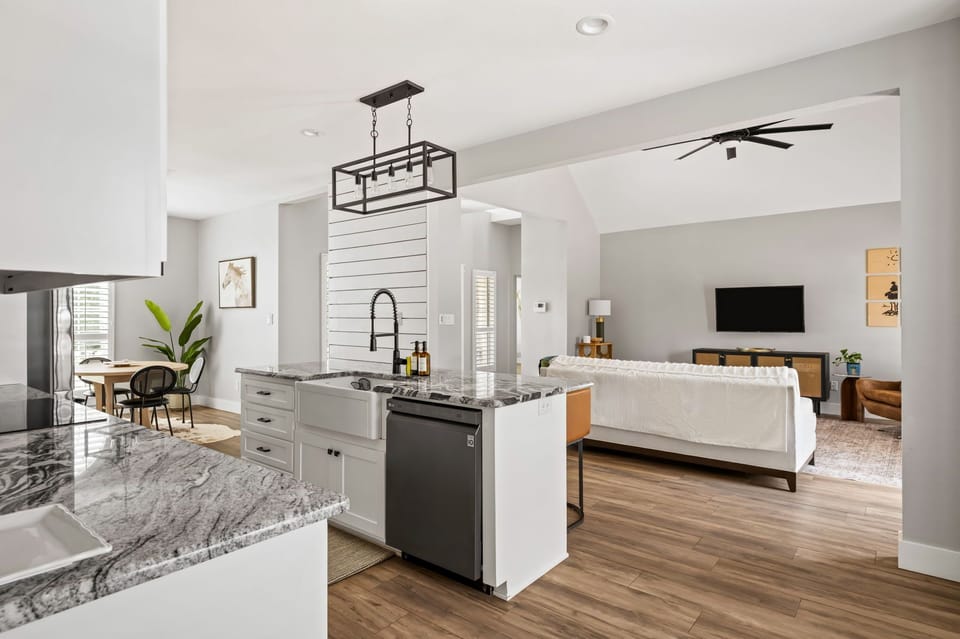 Bright open-concept kitchenette with a spacious island, perfect for cooking, serving, and staying connected with family and friends.