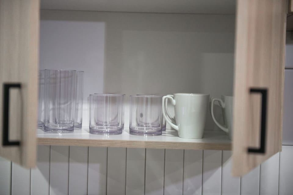 Enjoy your favorite drinks with our neatly stocked glasses and cozy mugs.