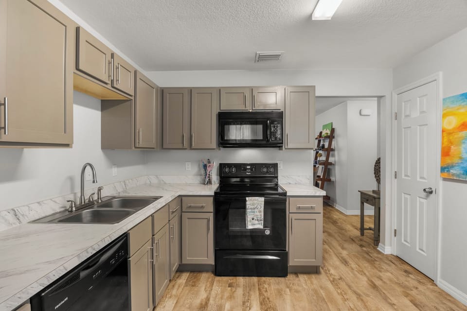 Unit #1 Left: Kitchen range & microwave.